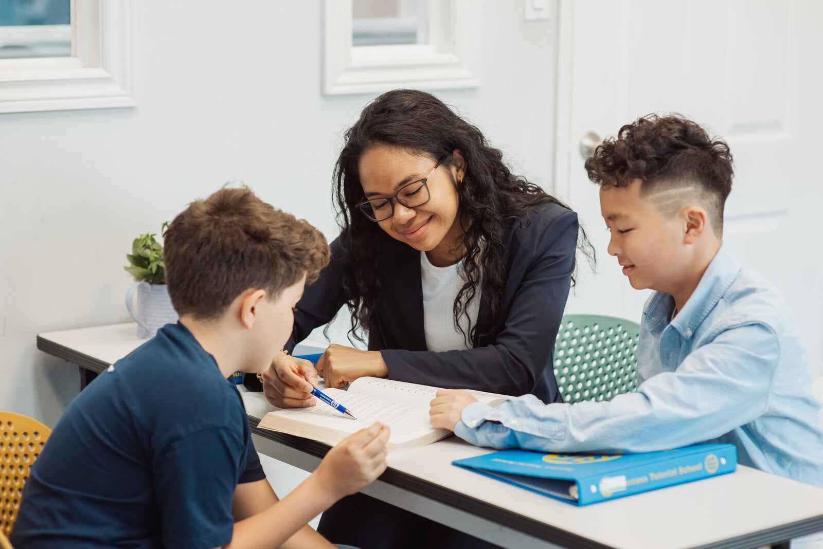 STS teacher helping students during a tutoring session